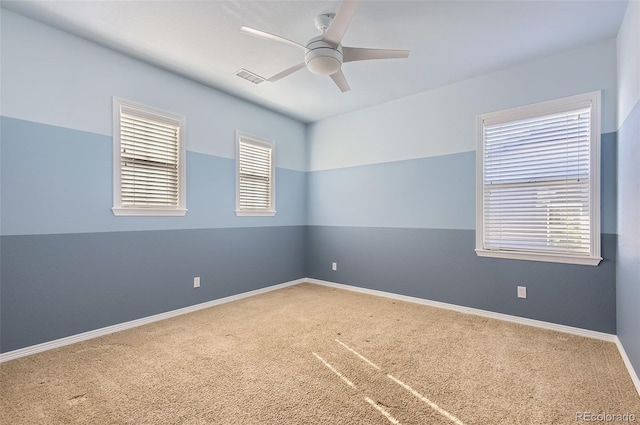 carpeted empty room featuring ceiling fan