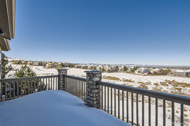 view of snow covered back of property