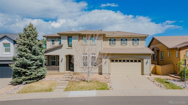 view of front of house featuring a porch, an attached garage, driveway, and stucco siding