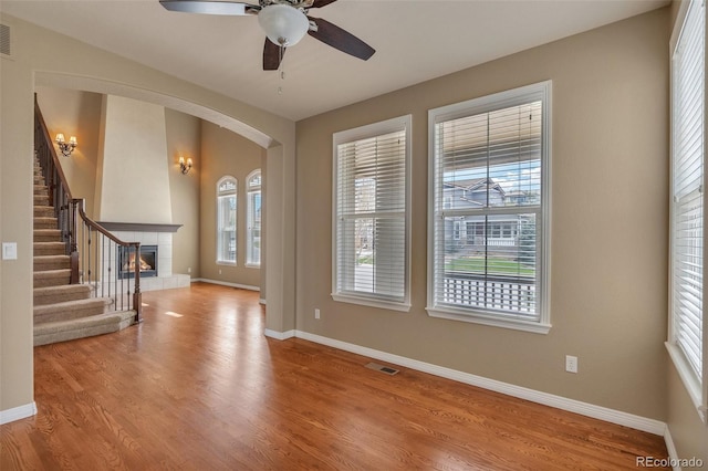 interior space with arched walkways, baseboards, and visible vents