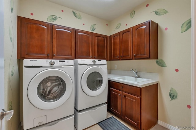 laundry room featuring a sink, cabinet space, and washing machine and clothes dryer
