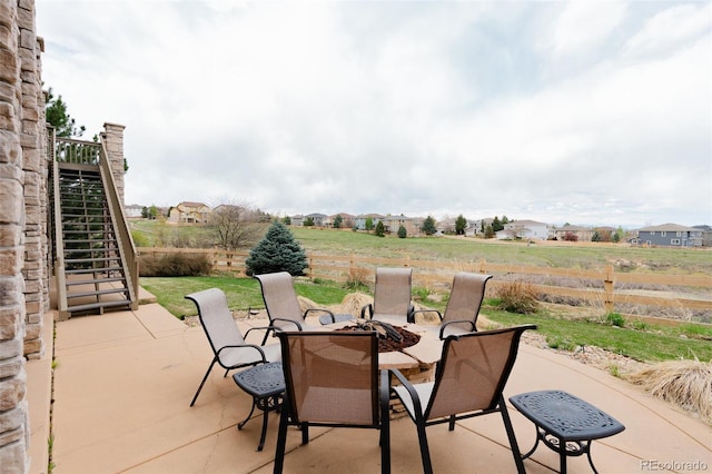 view of patio featuring a fire pit and fence