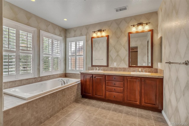 full bathroom featuring a sink, a healthy amount of sunlight, and visible vents
