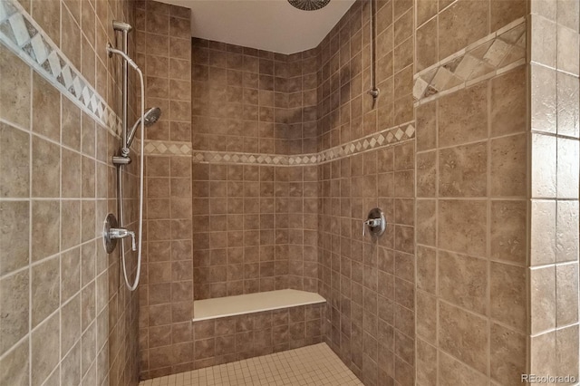 full bath featuring a tile shower