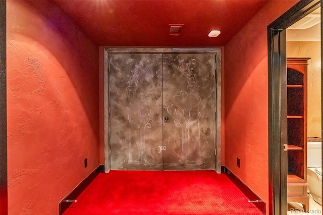 unfurnished room featuring visible vents and carpet