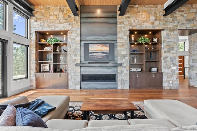 living room with wooden ceiling, a fireplace, beamed ceiling, and hardwood / wood-style flooring