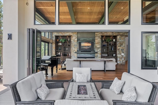 living room with a fireplace, beamed ceiling, wooden ceiling, and hardwood / wood-style floors