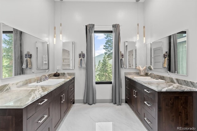 bathroom featuring a high ceiling, vanity, and tile patterned flooring