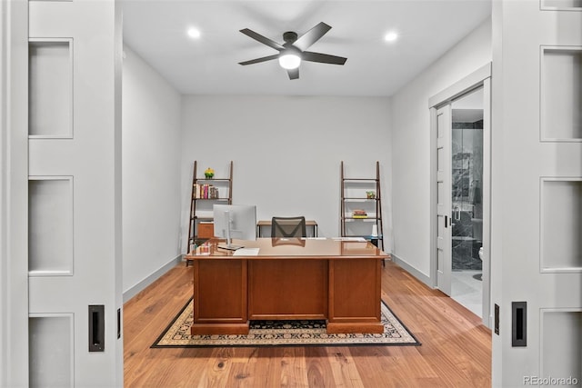 office space featuring ceiling fan and light hardwood / wood-style flooring