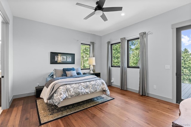 bedroom featuring wood-type flooring, access to outside, and ceiling fan