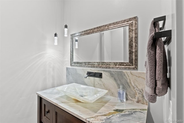 bathroom with vanity and tasteful backsplash