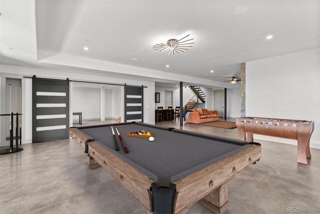 game room with concrete flooring, billiards, and a barn door