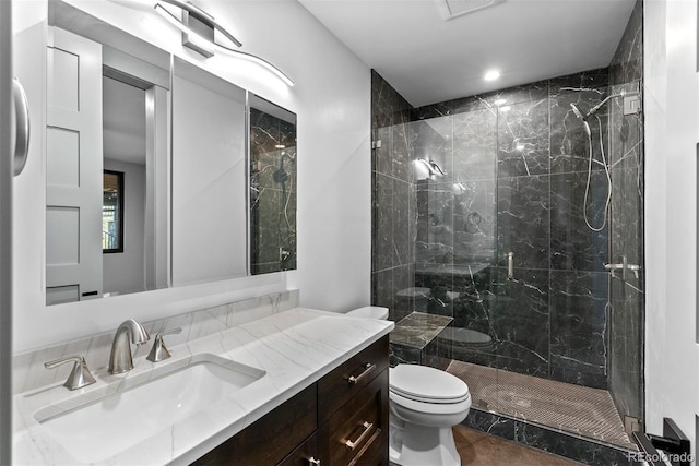 bathroom featuring vanity, tile patterned flooring, toilet, and a shower with door