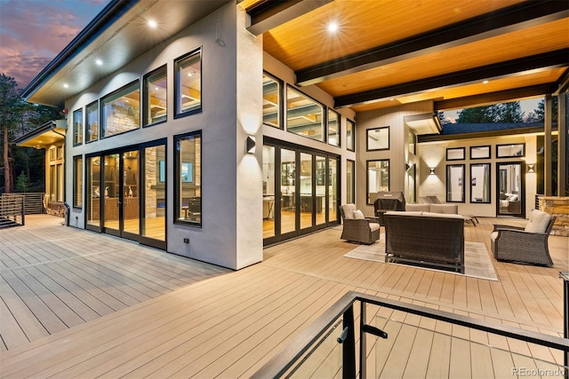 deck at dusk with an outdoor living space