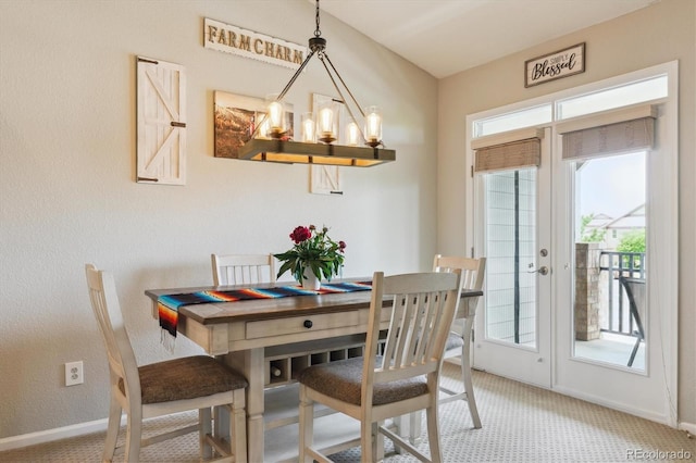 22932 E Ontario Dr Unit 102, Aurora, CO 80016 - carpeted dining space featuring a chandelier, healthy amount of natural light, and baseboards