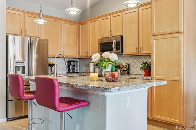 22932 E Ontario Dr Unit 102, Aurora, CO 80016 - kitchen featuring appliances with stainless steel finishes, decorative backsplash, light brown cabinets, and a sink