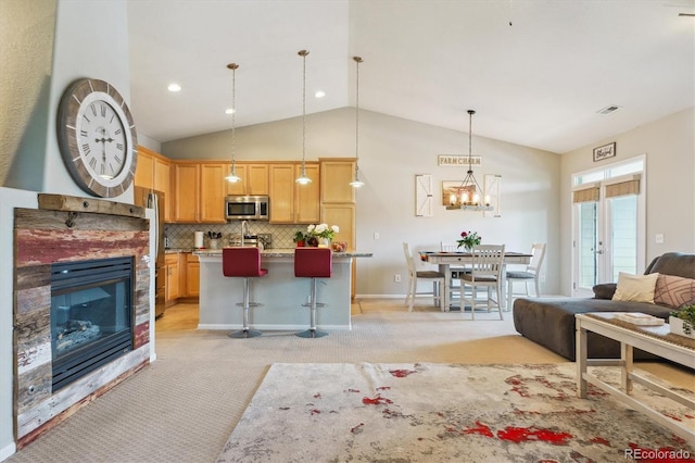 22932 E Ontario Dr Unit 102, Aurora, CO 80016 - kitchen featuring stainless steel appliances, open floor plan, light carpet, a chandelier, and decorative light fixtures