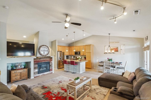 22932 E Ontario Dr Unit 102, Aurora, CO 80016 - living area with a ceiling fan, a glass covered fireplace, lofted ceiling, a chandelier, and baseboards
