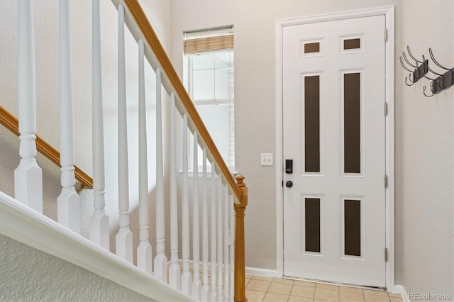 22932 E Ontario Dr Unit 102, Aurora, CO 80016 - entrance foyer featuring stairway, baseboards, and light tile patterned floors