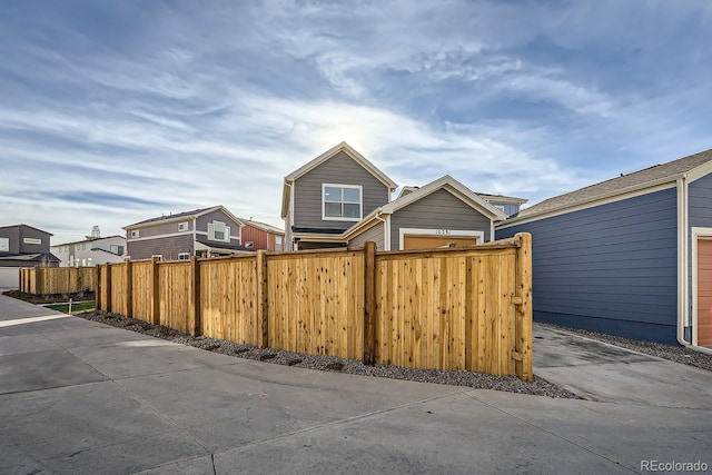 exterior space featuring fence and a residential view