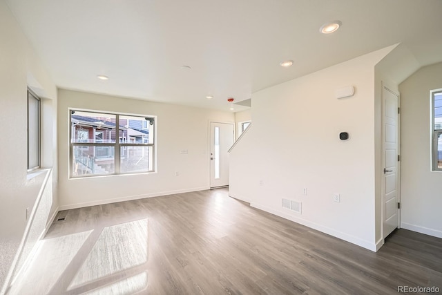 empty room featuring recessed lighting, wood finished floors, visible vents, and baseboards