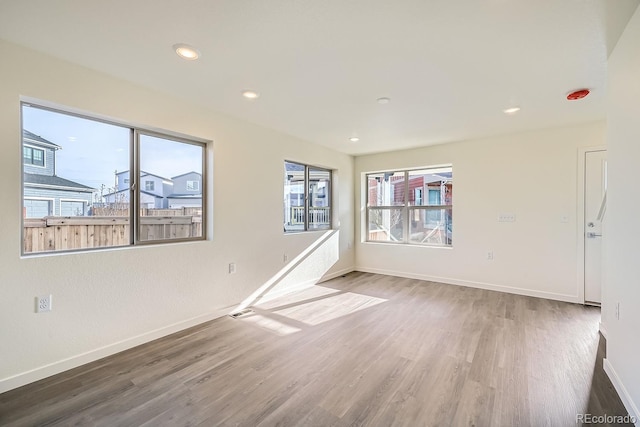 spare room with visible vents, recessed lighting, wood finished floors, and baseboards