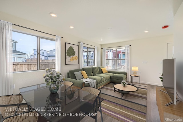 living room with recessed lighting, wood finished floors, and baseboards