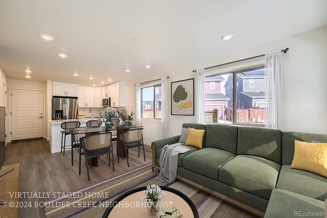 living room with recessed lighting, baseboards, and dark wood-style flooring