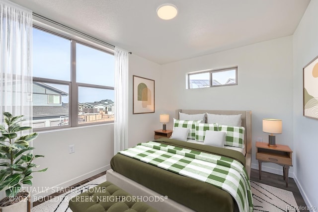 bedroom featuring baseboards and wood finished floors