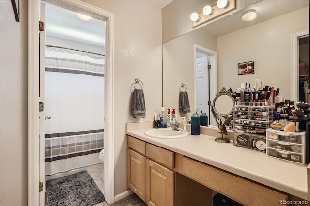 bathroom featuring tile patterned flooring, vanity, and toilet