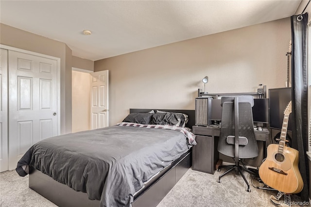 bedroom with a closet and light carpet