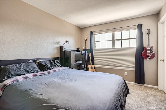 bedroom with a textured ceiling and carpet floors