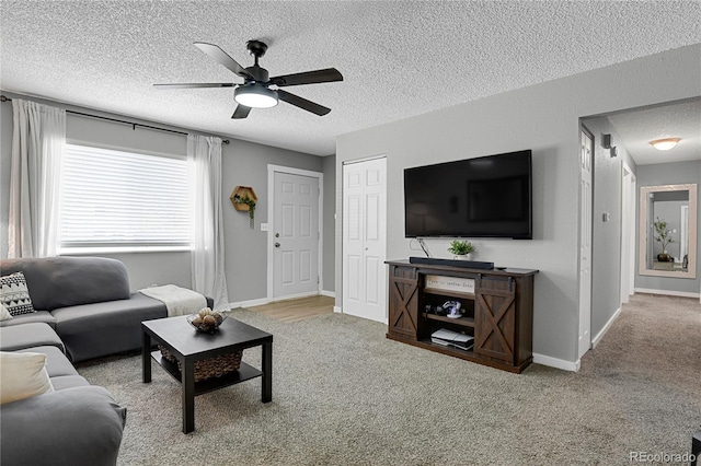 2185 Ambleside Dr, Colorado Springs, CO 80915 - carpeted living room featuring a textured ceiling, ceiling fan, and baseboards