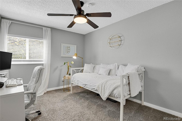 2185 Ambleside Dr, Colorado Springs, CO 80915 - bedroom with an office area, carpet floors, a textured ceiling, a ceiling fan, and baseboards