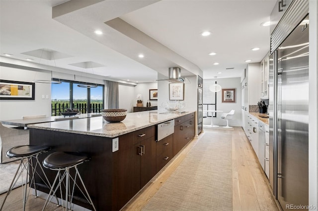 460 S Marion Pkwy Unit 1856, Denver, CO 80209 - kitchen featuring built in refrigerator, a kitchen breakfast bar, modern cabinets, dark brown cabinets, and a warming drawer