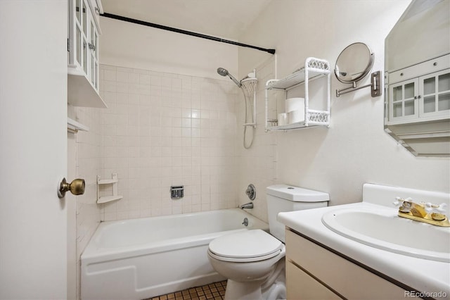 full bathroom featuring toilet, vanity, tile patterned flooring, and tiled shower / bath