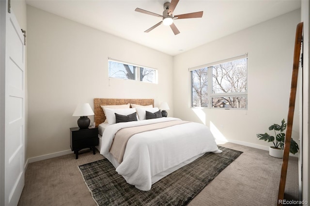 carpeted bedroom featuring a ceiling fan and baseboards