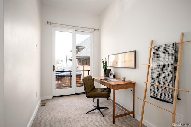 carpeted office with visible vents and baseboards