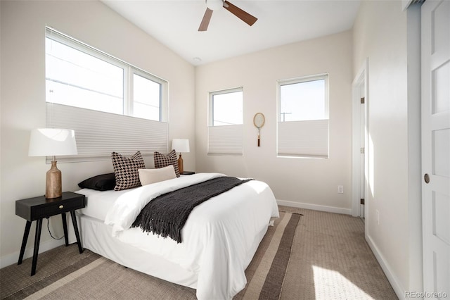 bedroom featuring ceiling fan, baseboards, and carpet floors