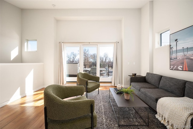 living area featuring baseboards and wood finished floors