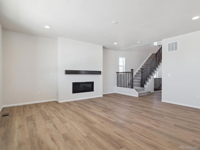 unfurnished living room with light hardwood / wood-style flooring