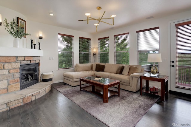 10609 Chadsworth Ln, Highlands Ranch, CO 80126 - living area featuring dark wood finished floors, a chandelier, a stone fireplace, and baseboards