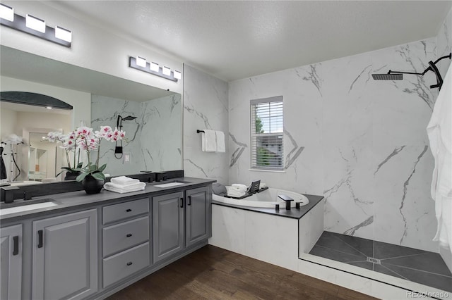 10609 Chadsworth Ln, Highlands Ranch, CO 80126 - full bath with double vanity, a marble finish shower, a bath, wood finished floors, and a textured ceiling