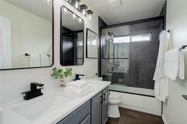 10609 Chadsworth Ln, Highlands Ranch, CO 80126 - full bath with toilet, double vanity, wood finished floors, and enclosed tub / shower combo