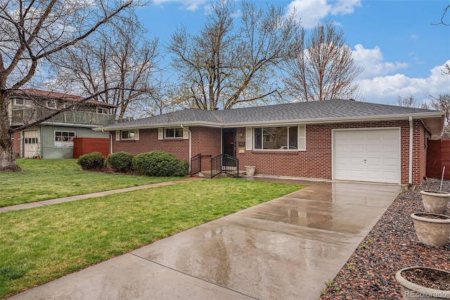 ranch-style house featuring a front lawn, brick siding, a shingled roof, concrete driveway, and an attached garage