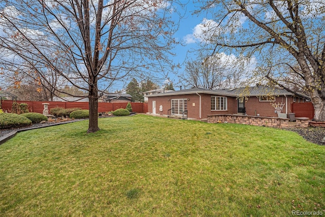 view of yard featuring a fenced backyard and a garage