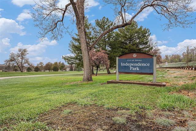 community / neighborhood sign with a yard