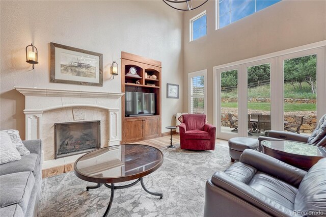 9121 Sunshine Meadow Pl, Parker, CO 80134 - living area featuring wood finished floors, a high end fireplace, and a towering ceiling