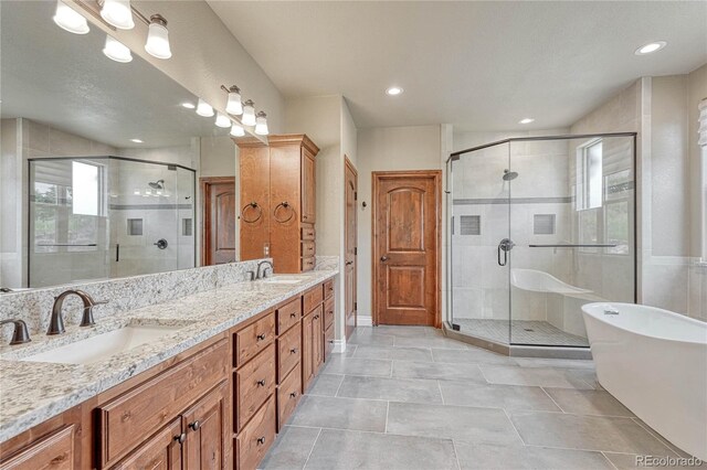 9121 Sunshine Meadow Pl, Parker, CO 80134 - full bathroom with a stall shower, a soaking tub, double vanity, tile patterned floors, and recessed lighting