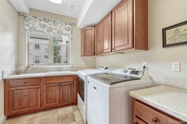 9121 Sunshine Meadow Pl, Parker, CO 80134 - washroom featuring washer and dryer, cabinet space, and light stone finish flooring